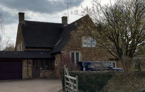 Front elevation of Orchard House, a detached 1970 stone house near Banbury
