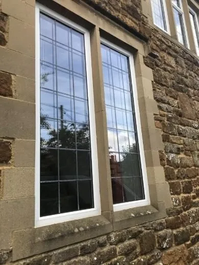 Slim-frame glazing set in insulated original stone mullions at Orchard House