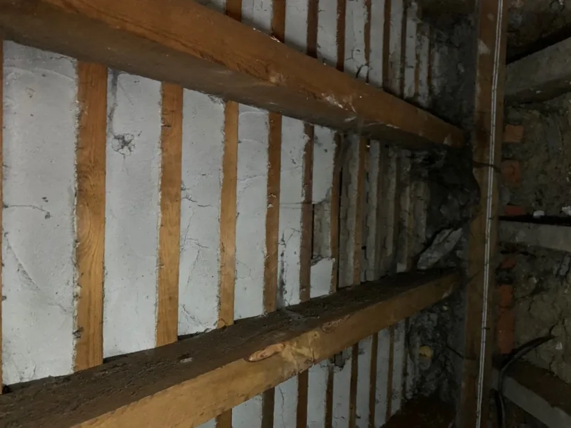 Inside the roof before works: lime torching between battens and no insulation in the slope