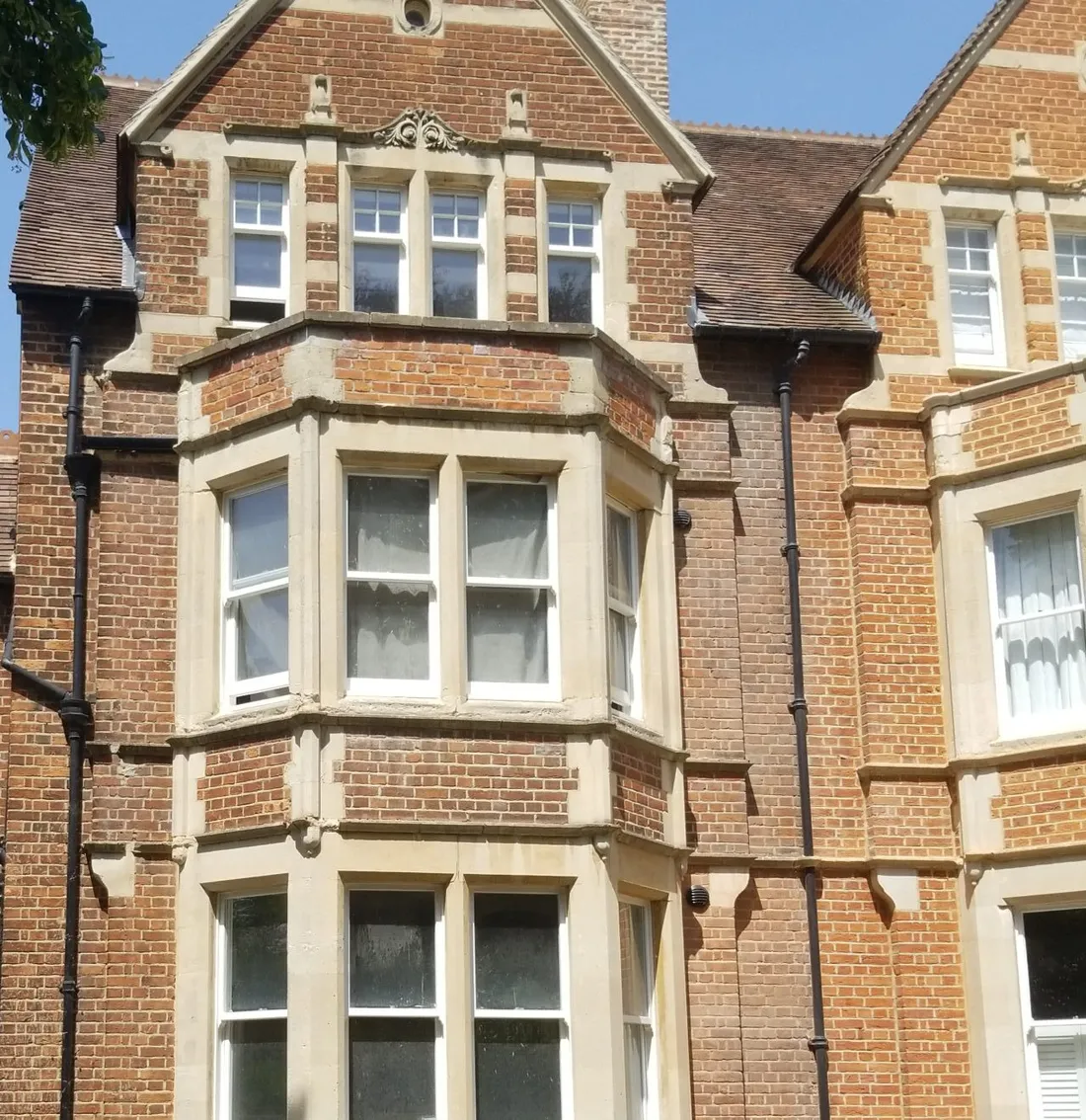 Front elevation of the 1880s Victorian semi on St Margaret's Road after retrofit — ornamental brick, stone-dressed bays and new timber sashes