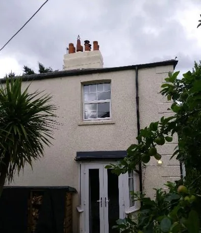 Side elevation with a mix of window ages and styles