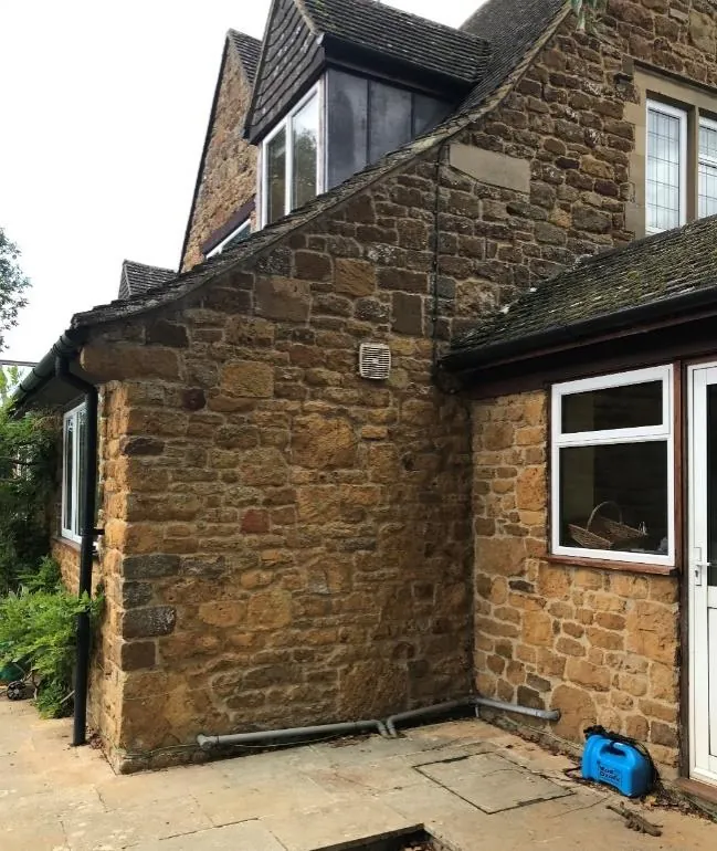Stone external wall studied as the location for an air source heat pump
